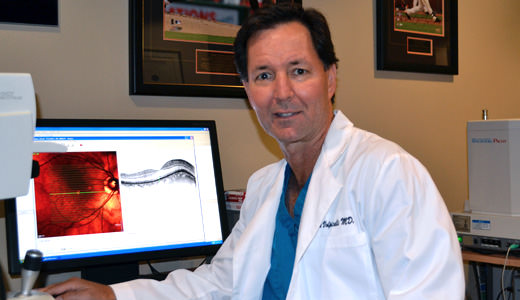 Dr. Volpicelli reviewing a patients retinal findings on the OCT device